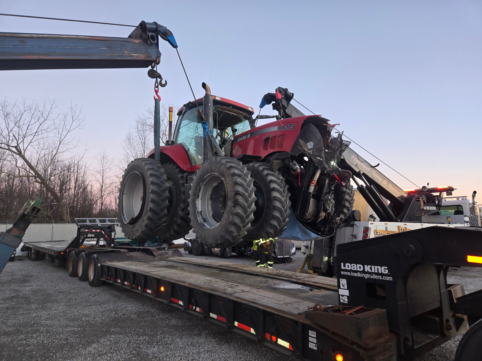 Heartland Towing hauling a Case tractor on a lowboy trailer